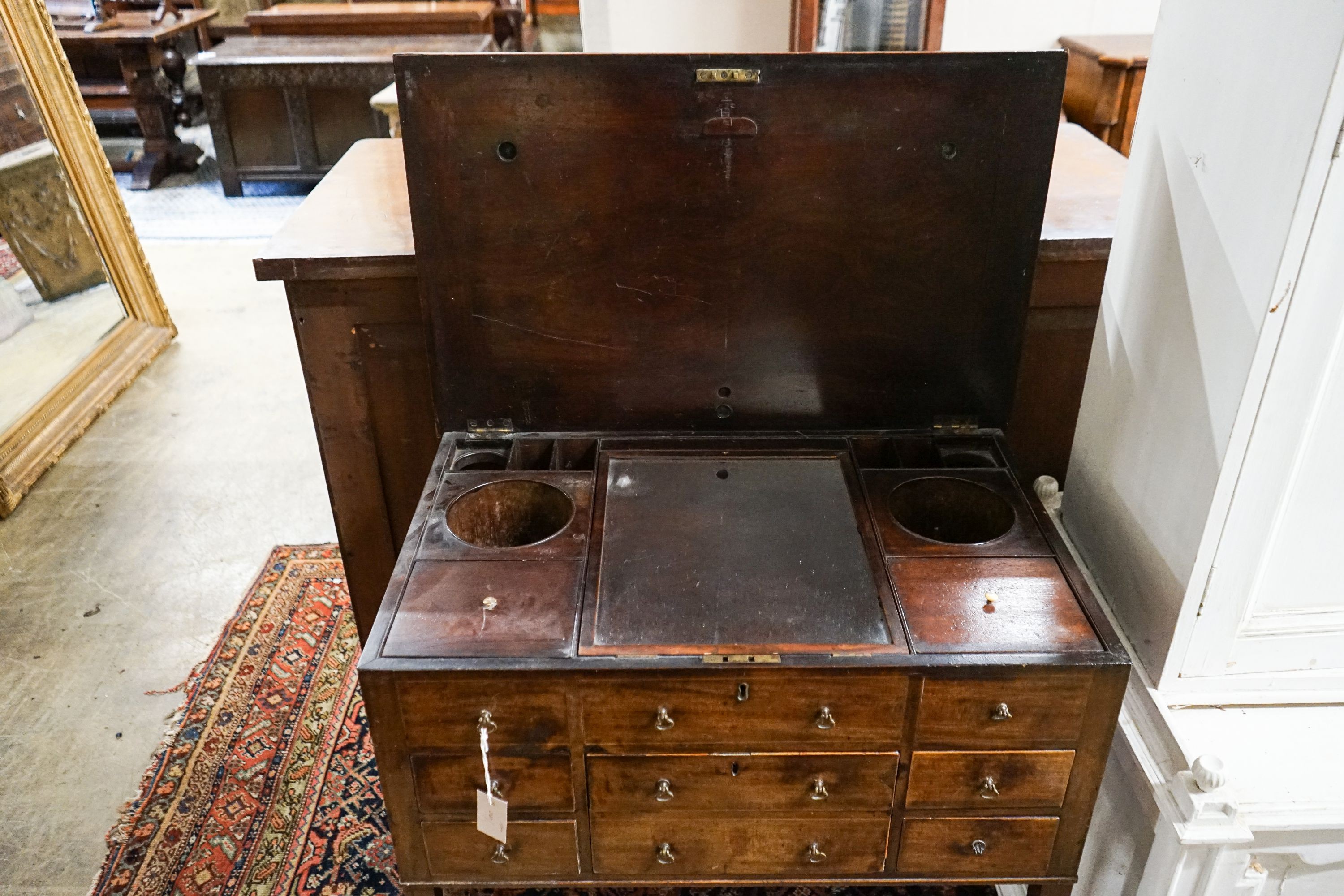 A George III mahogany enclosed washstand with hinged top, width 78cm, depth 49cm, height 84cm